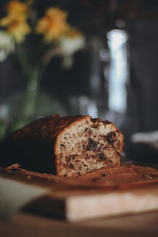 loaf of bread with raisins sitting on the side