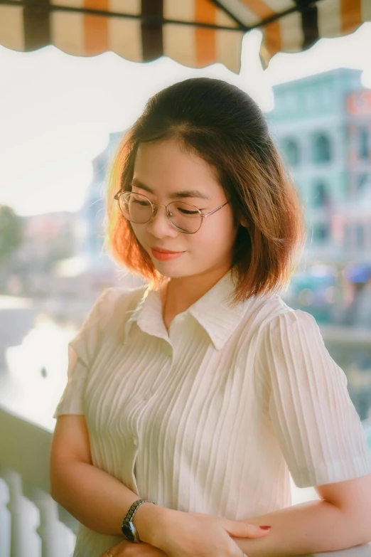 a woman in a white shirt stands by the railing