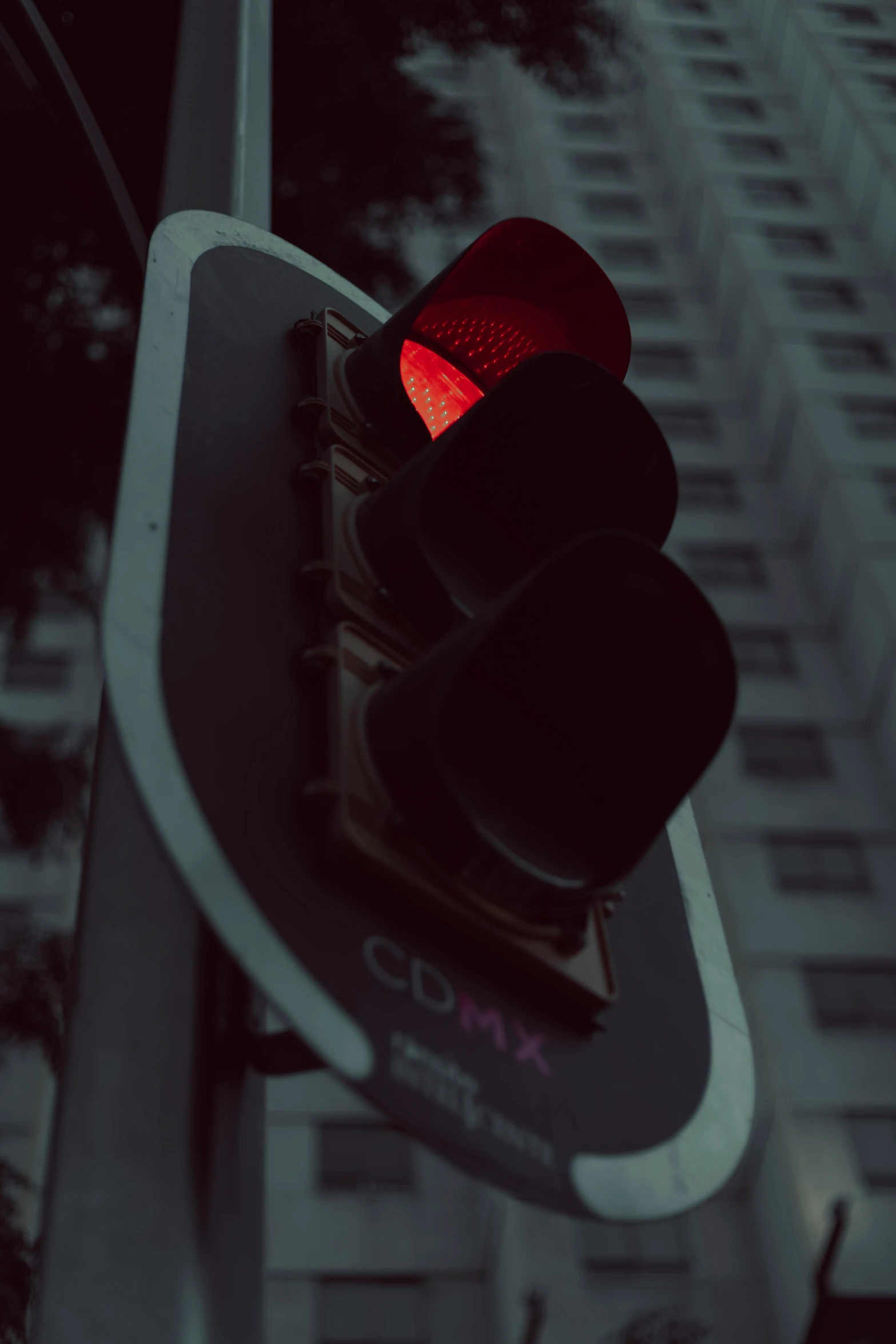 traffic signal at the street corner with a building in background