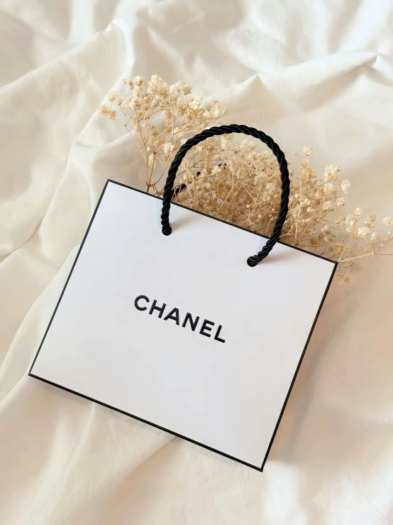 the word chanel written on a white bag