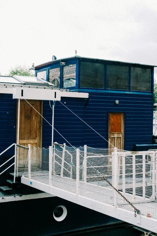 a building with a white fence and gate near it