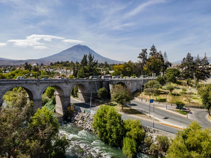 a bridge with some water and road traffic below