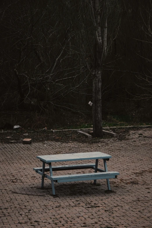 a bench sits alone outside in the snow