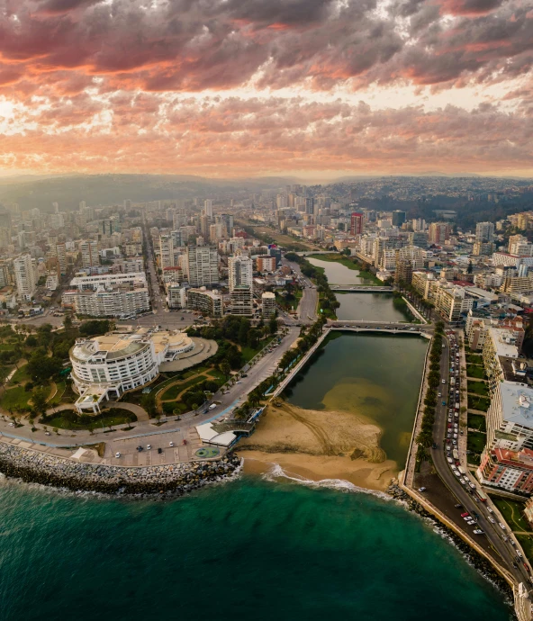 a city and a large body of water at dusk