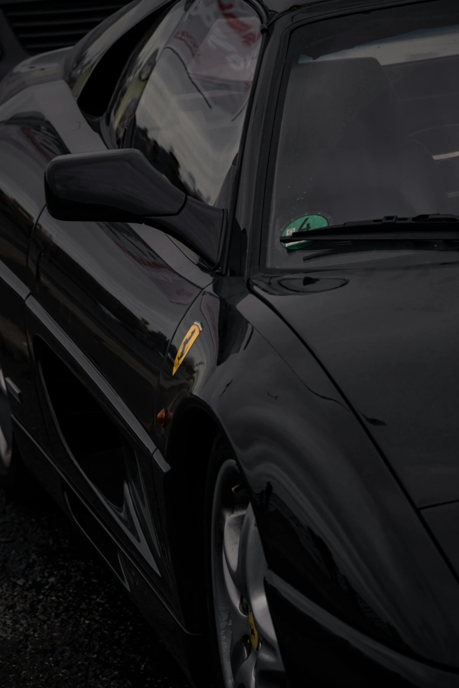 a black sports car parked next to another car