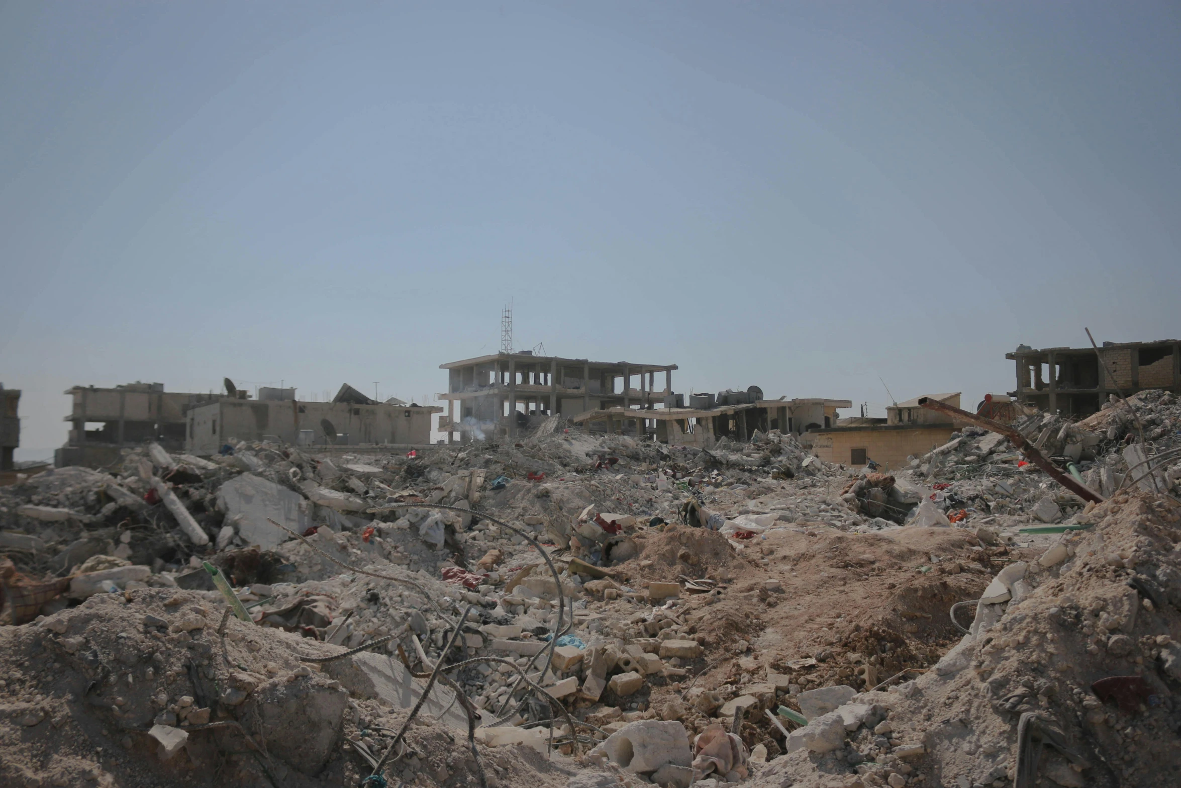 an old and torn building with rubble piled to it