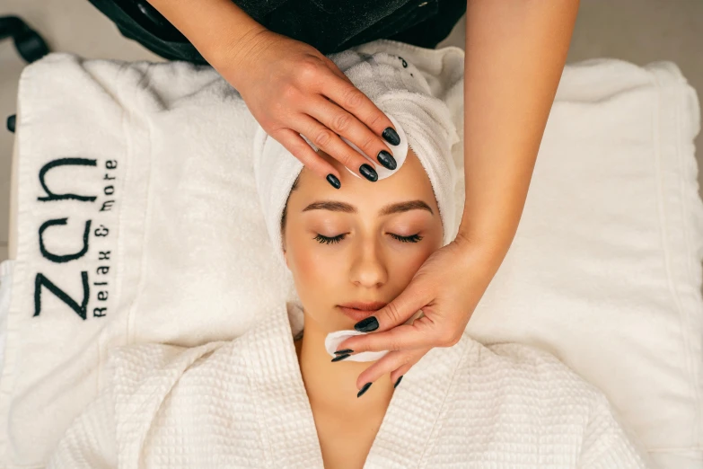 woman getting a facial massage at a spa