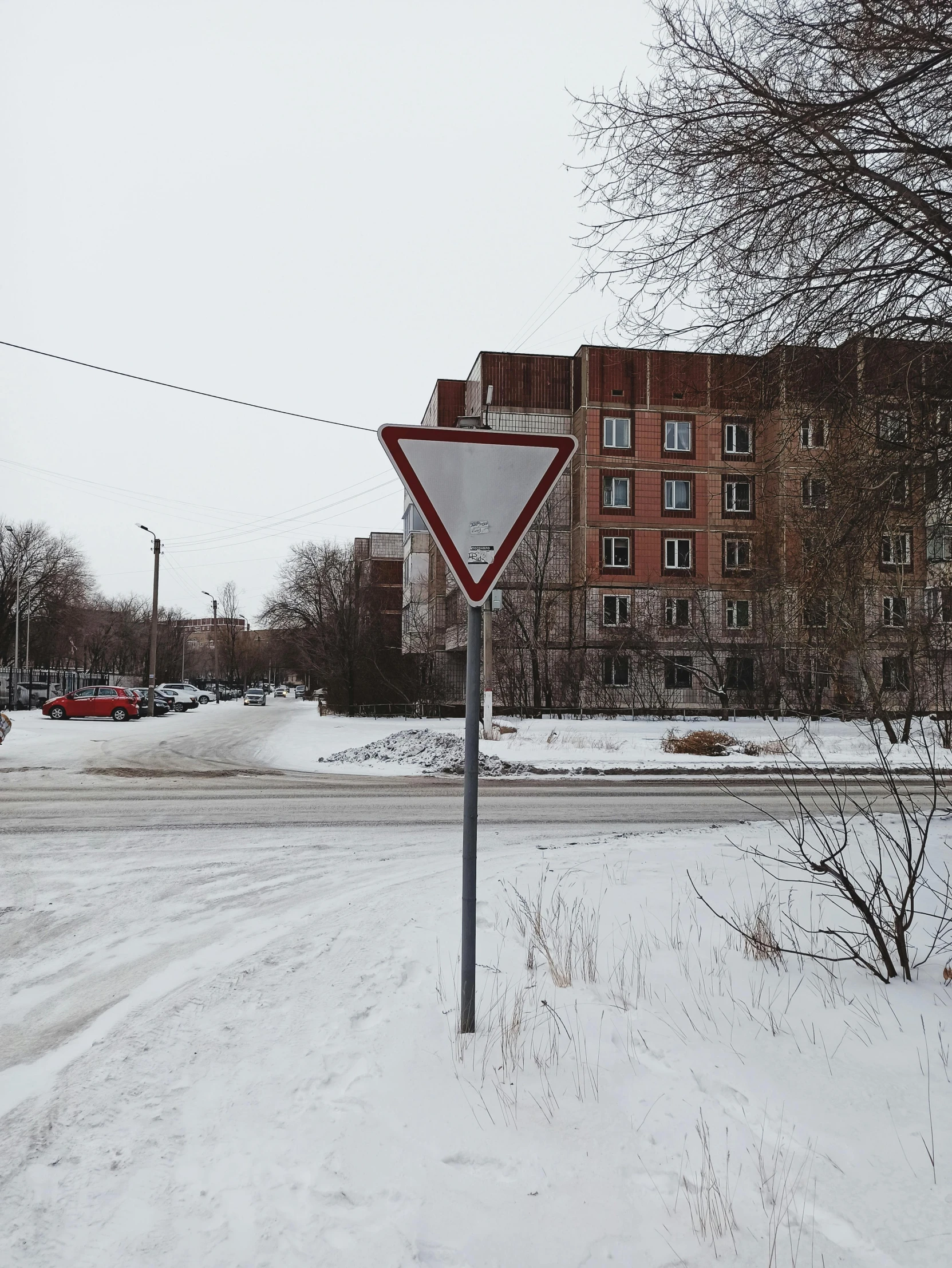 a traffic sign that is by a road in the snow