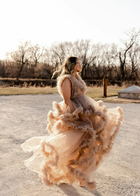 a woman wearing a long dress and posing for a pograph