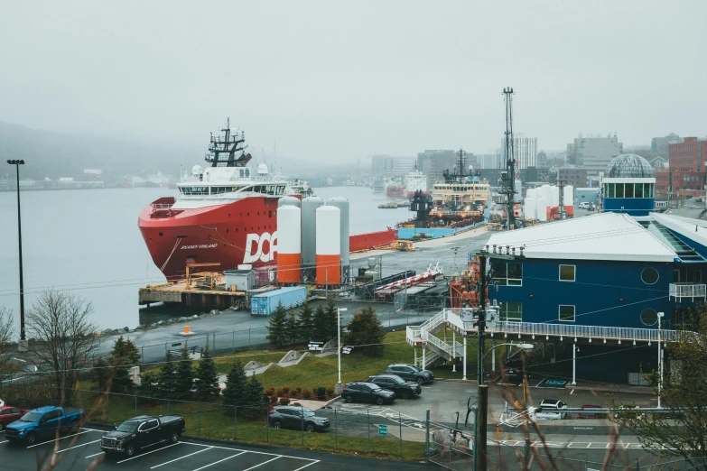 two ships are docked in the harbor with snow on them