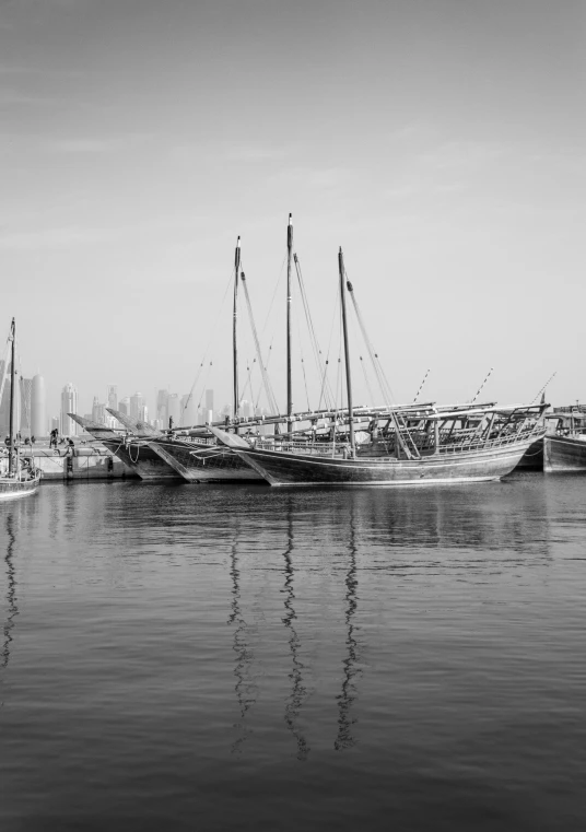 a black and white po of sail boats docked in harbor