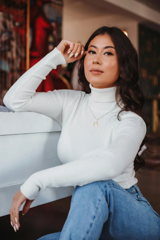 a woman in white shirt sitting on a couch