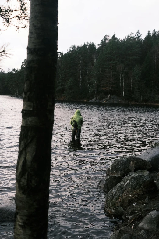 the man is fishing on the lake by himself