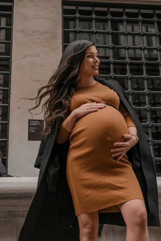 a pregnant woman walking down the street