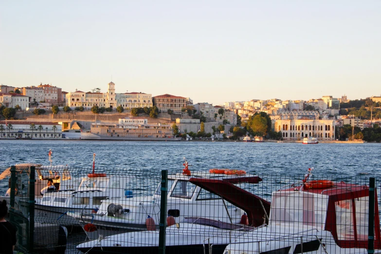 some white and red boats are tied to the dock