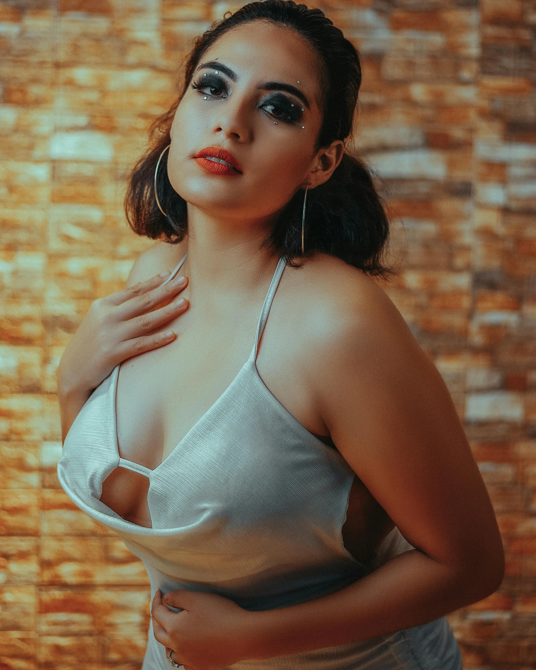 woman in lingerie with handmade  posing in front of brick wall