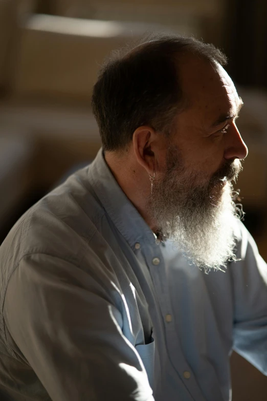 a man with a long beard and white shirt