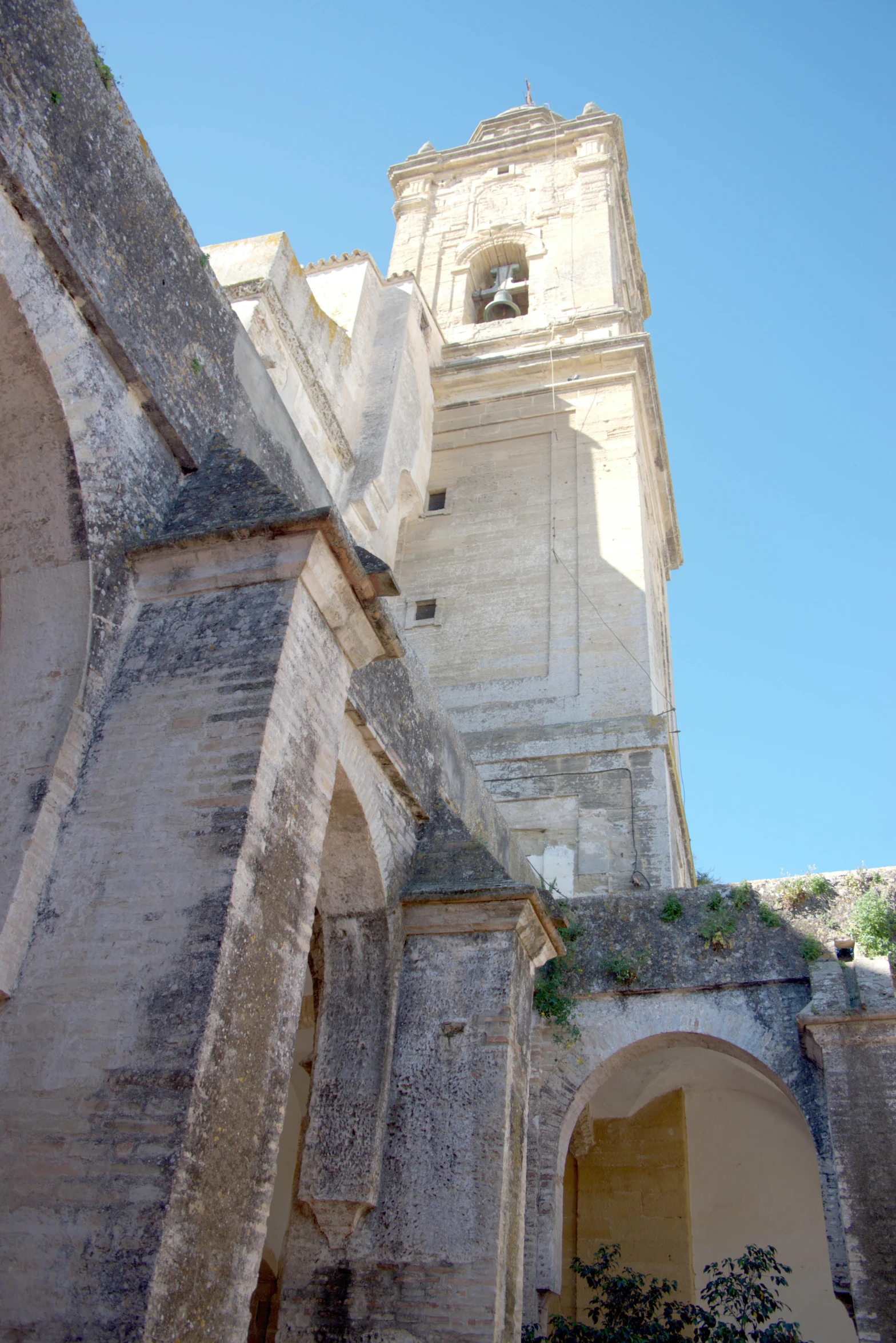 a tall clock tower with arches and doorways