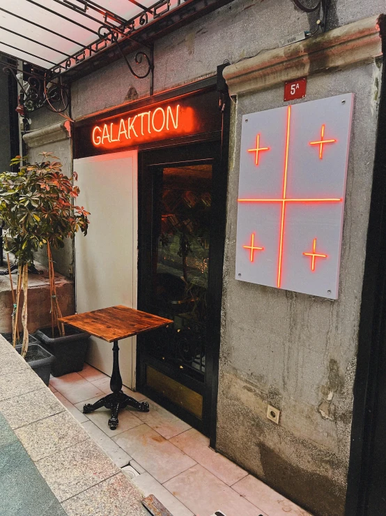 a restaurant on the side of a street with a neon sign