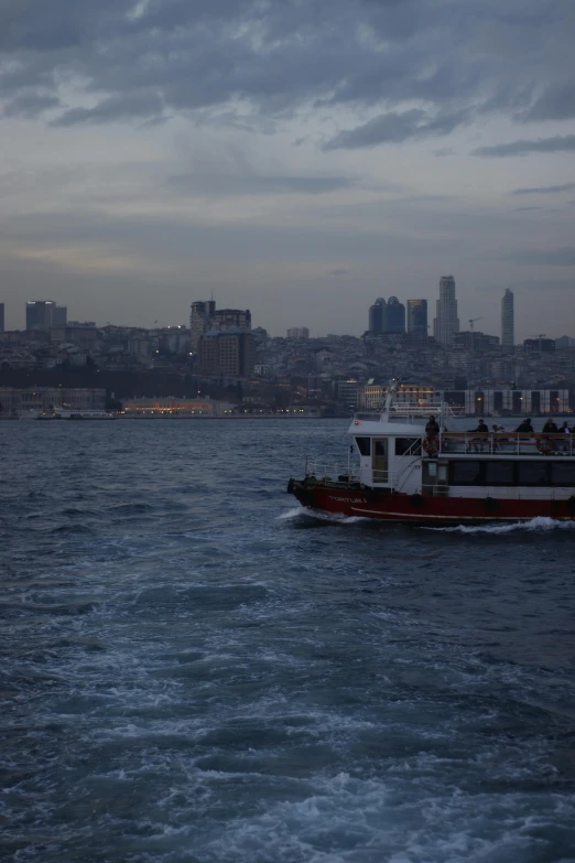 a boat in the water near large buildings