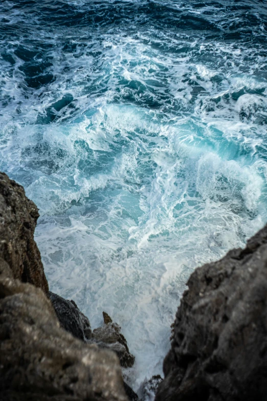 the rock cliffs look out over rough seas