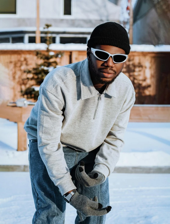 a man is wearing sun glasses and holding onto a snowboard