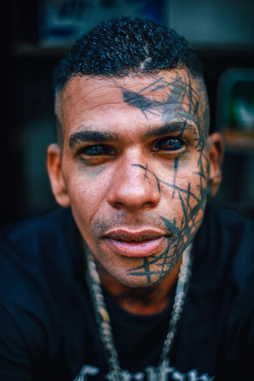 a man has a lot of ink on his face