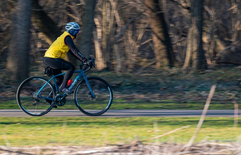 a person wearing bicycle gear on a rural road