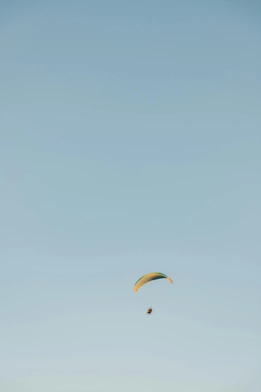 a pair of para - sailing gliders are in the air