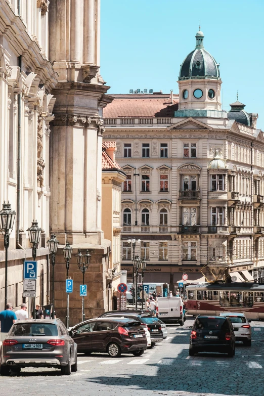 a view of a street with cars parked on the road