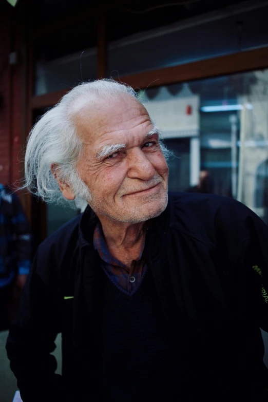 a man who is standing outside in a black jacket