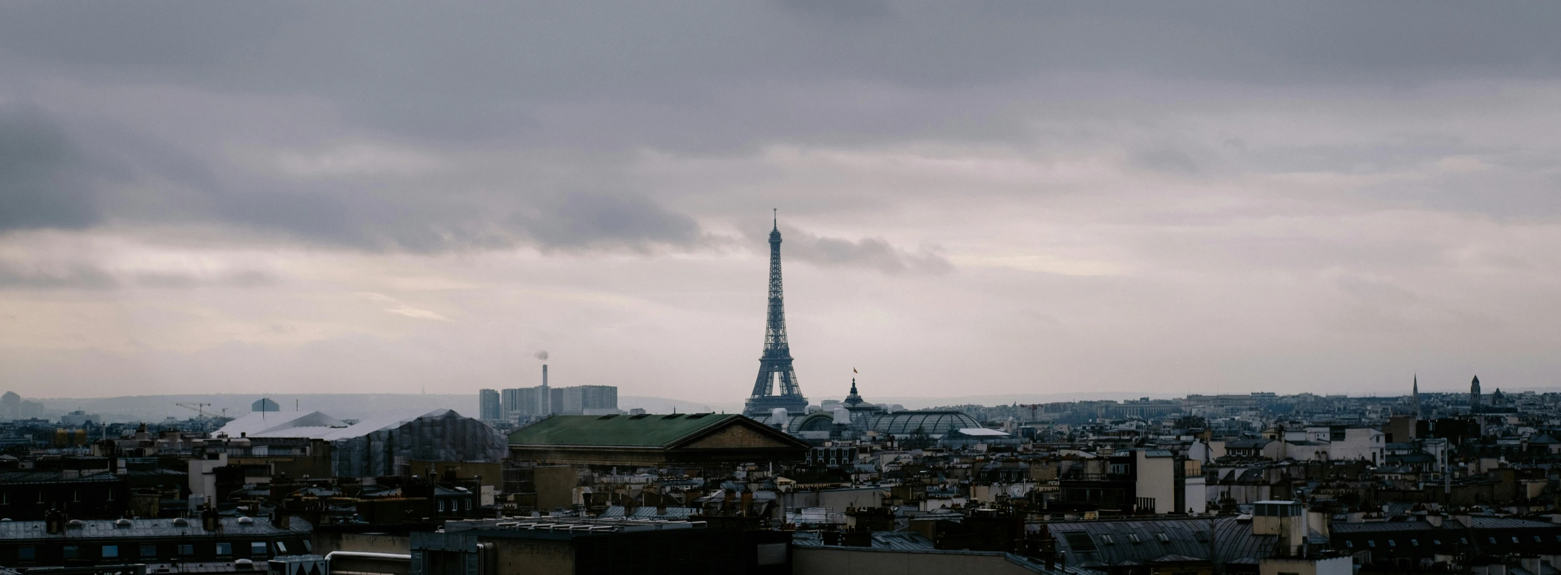 the city with all the buildings on it is under dark clouds