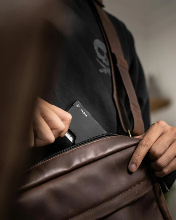 a man holds a briefcase and a wallet