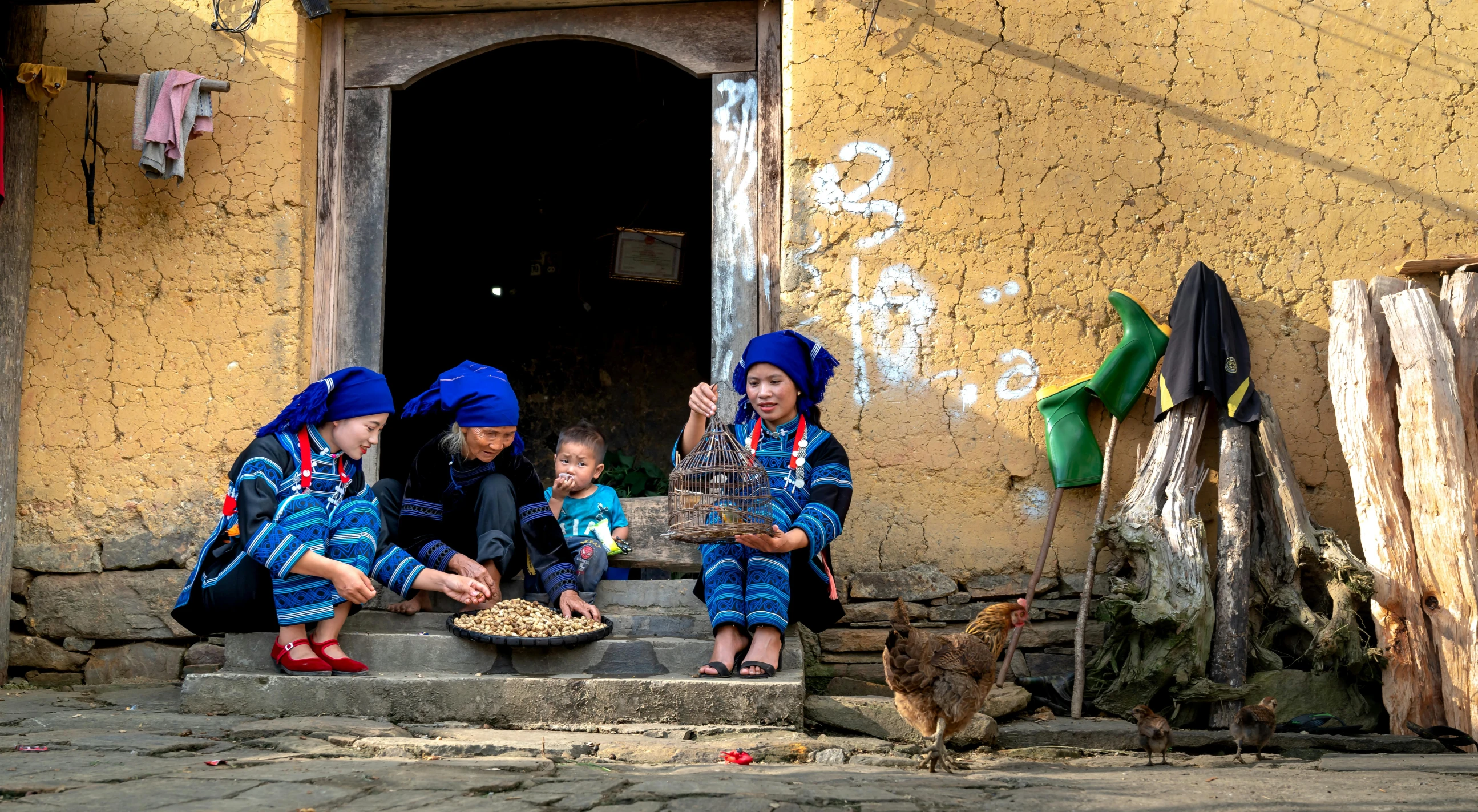 three boys eating from bowls sitting on steps