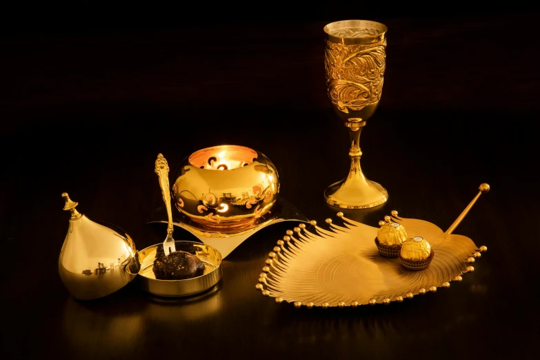 a table topped with lots of gold dishes