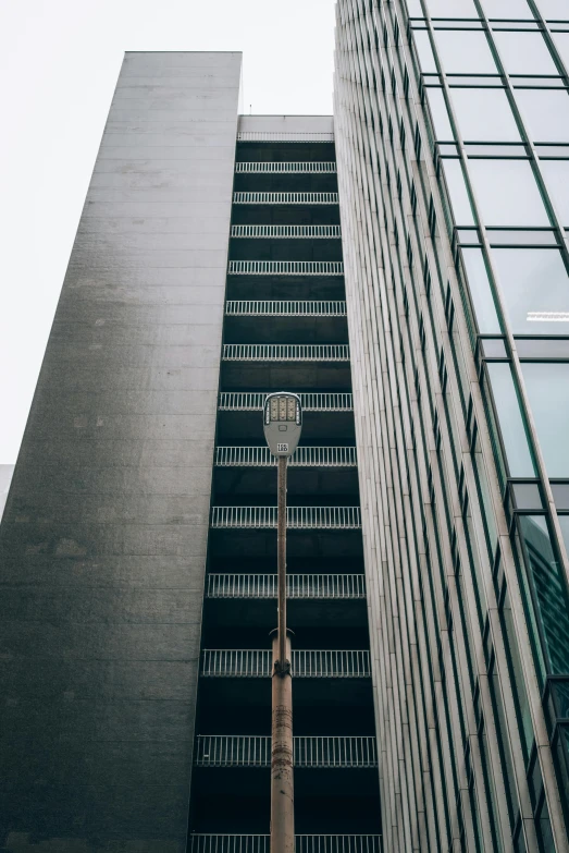 two tall buildings with a street sign near one