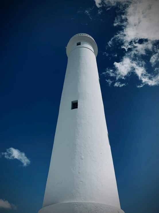 a white lighthouse on top of a tall building