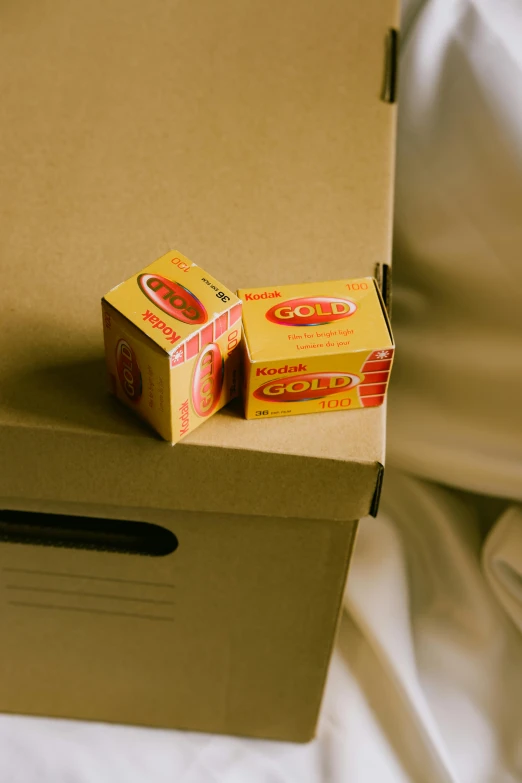 two boxed boxes are sitting on the top of a mattress