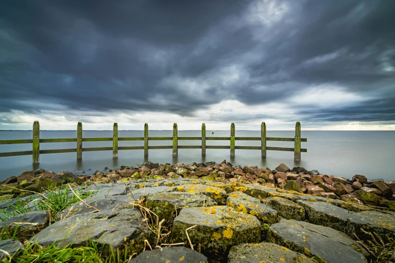 a wooden pier sitting on top of a cliff near the ocean