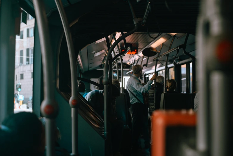 people riding a commuter bus in the city