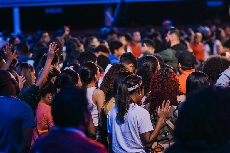 a large group of people sitting in the middle of a crowd