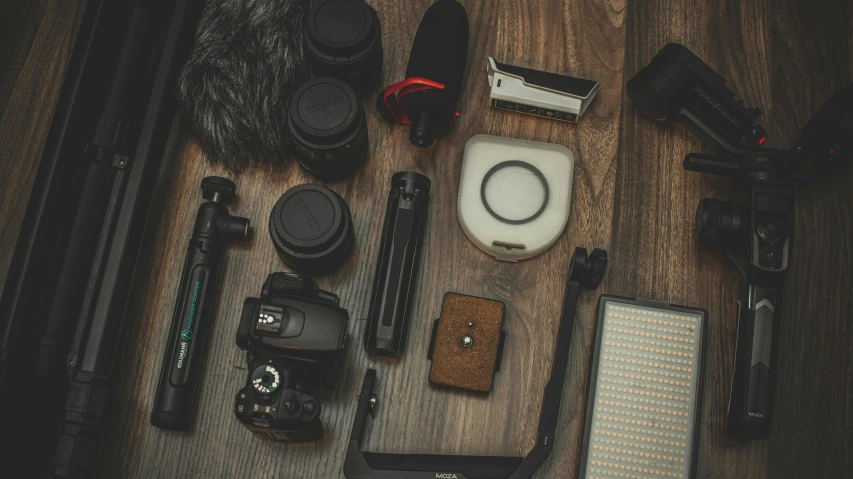 the contents of a camera on a wood surface