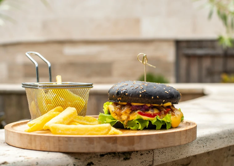 a very big tasty looking cheeseburger with fries on the side