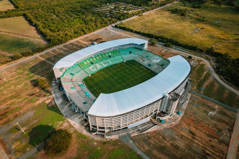 an aerial view of a stadium with trees and land