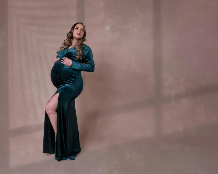 a woman standing on one leg in a blue dress and with her arms crossed