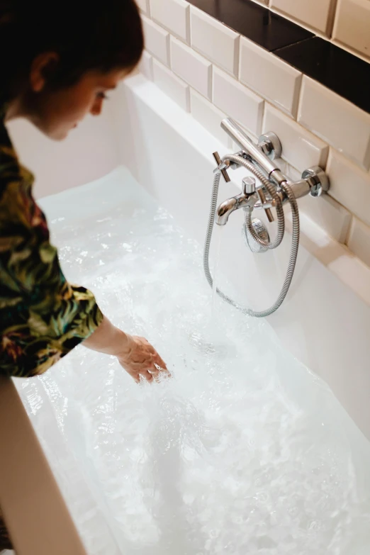 a woman taking a bath with bubbles and soap