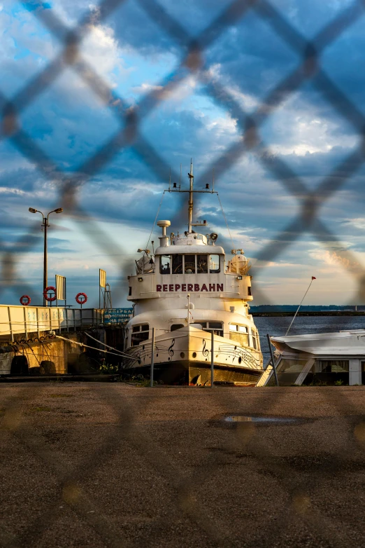 there are two boats next to each other behind a fence