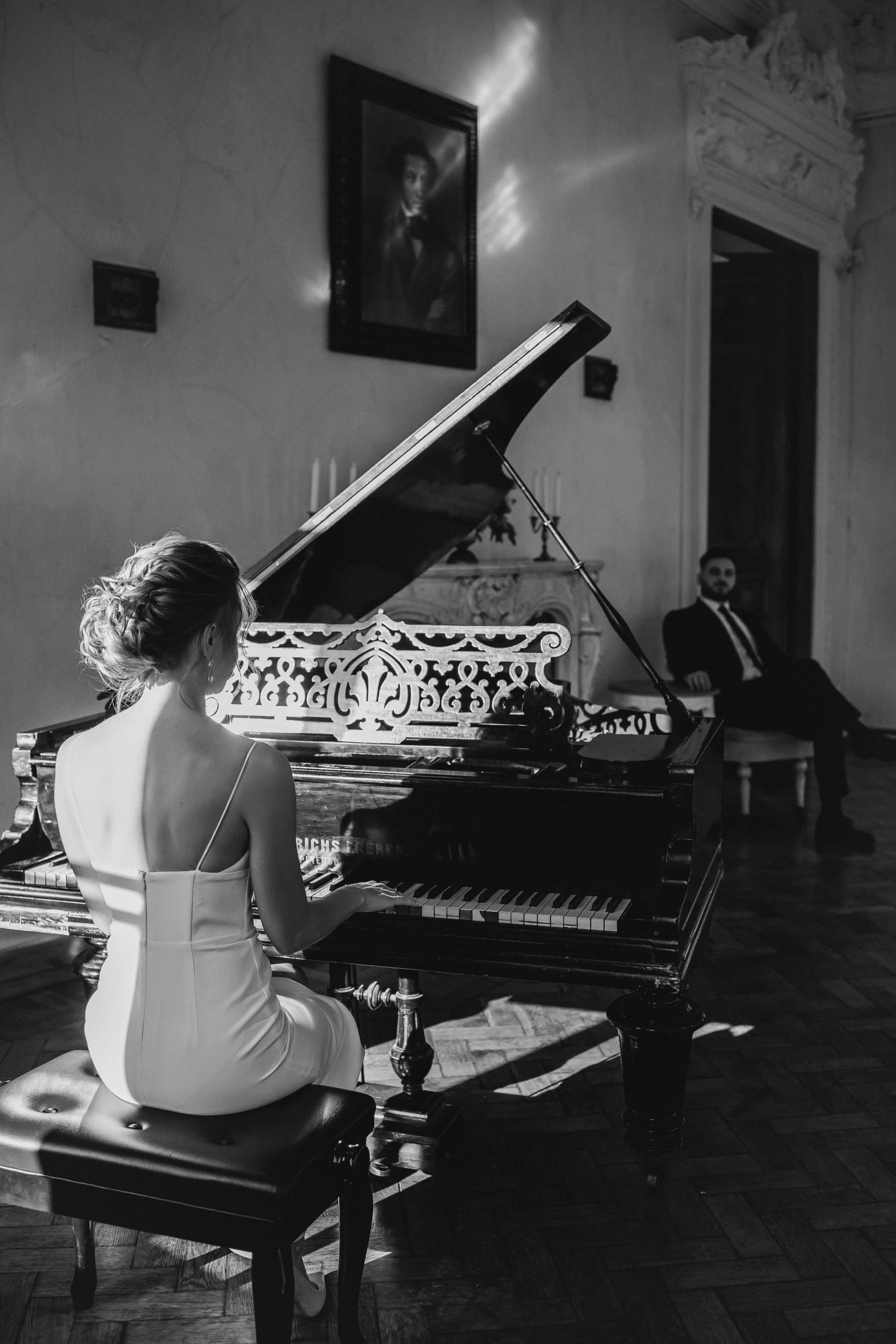 woman sitting on chair and playing piano