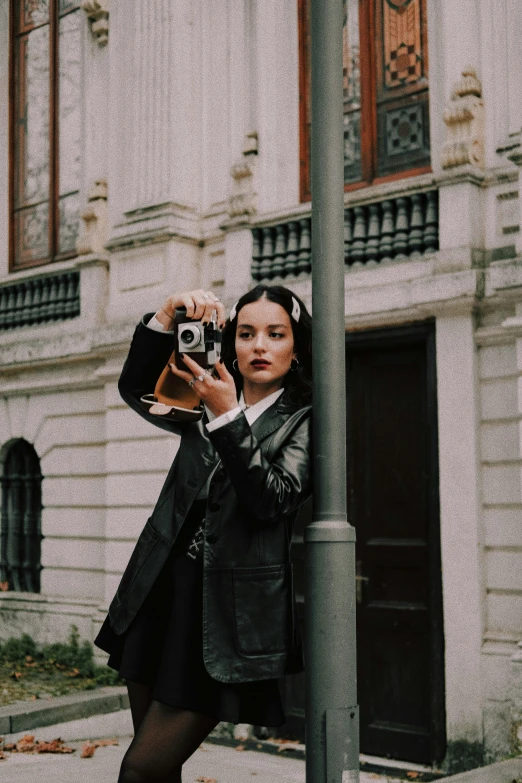 a woman holding up a camera with her hands