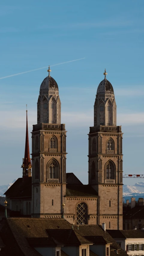 two towers in front of a snowy mountain